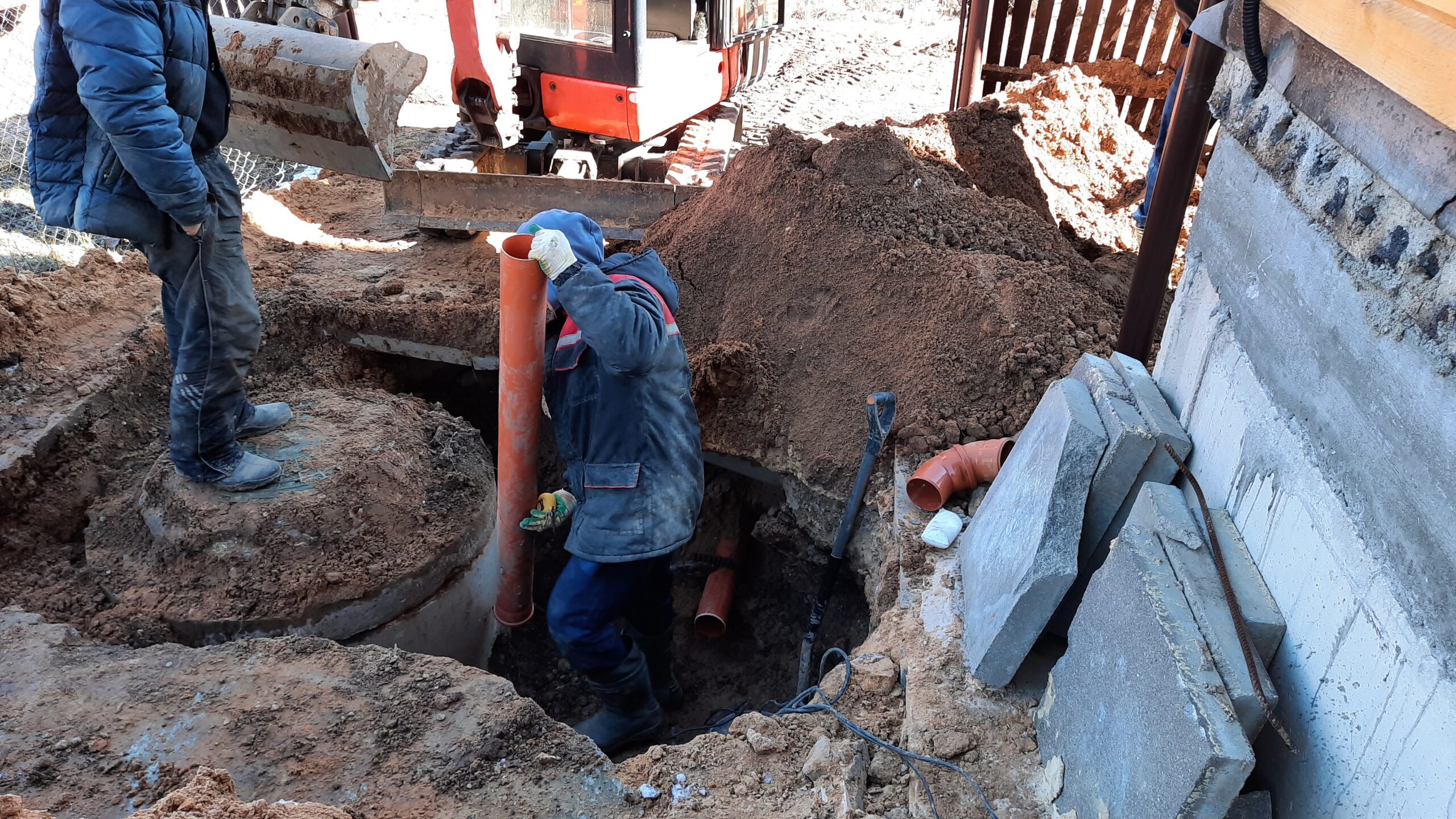 construction-worker-assembles-sewer-pipes-into-a-s-2021-09-02-14-13-50-utc
